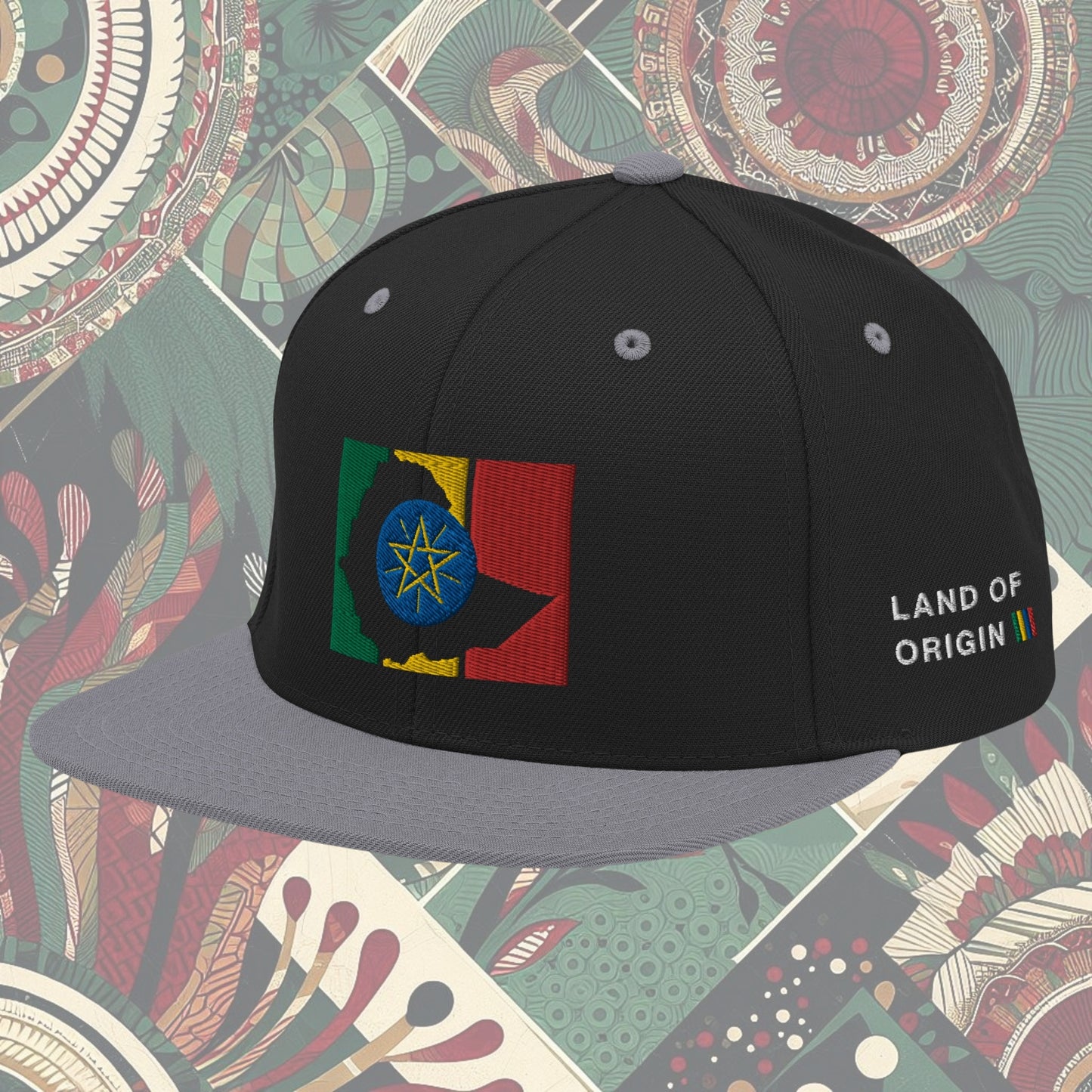 grey brim Ethiopia flag snapback from a Black-owned business with 'Land of Origin' on the side. Features vibrant flag colors. Perfect for showing national pride. Available now.