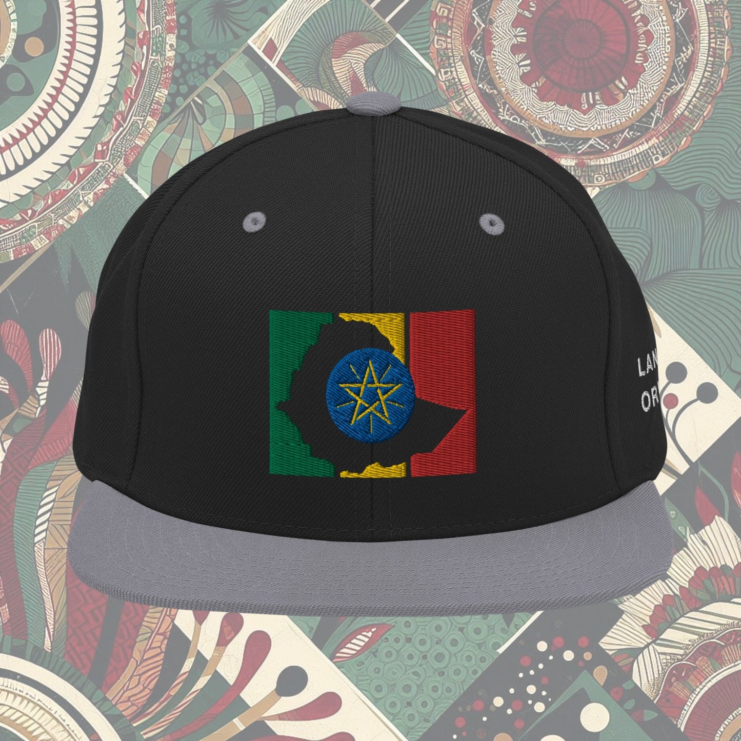 grey brim Ethiopia flag snapback from a Black-owned business with 'Land of Origin' on the side. Features vibrant flag colors. Perfect for showing national pride. Available now.
