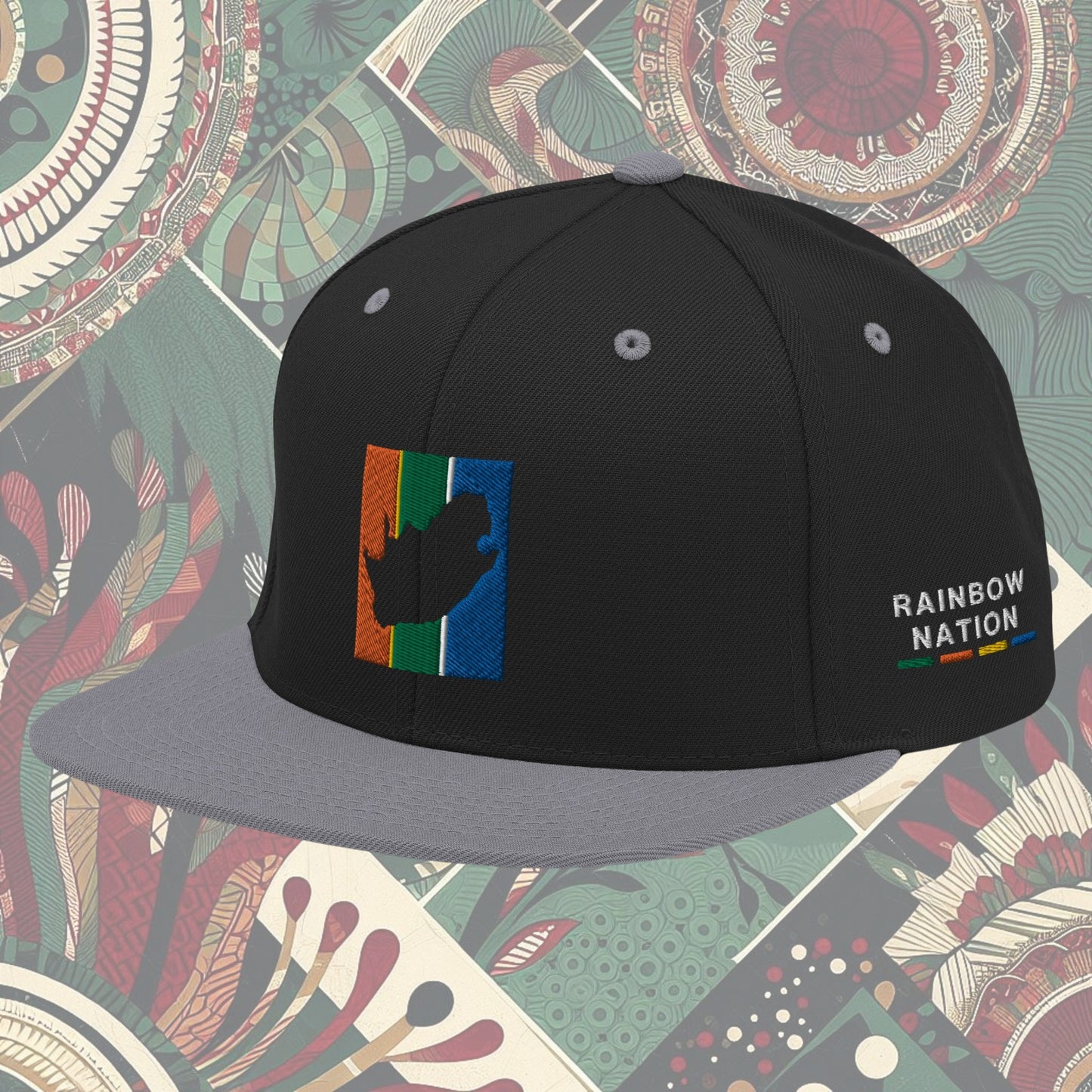 Grey brim South Africa flag snapback with 'Rainbow Nation' written on the side. Features vibrant flag colors and a statement celebrating South Africa's diversity. Ideal for showcasing pride and enhancing your style.