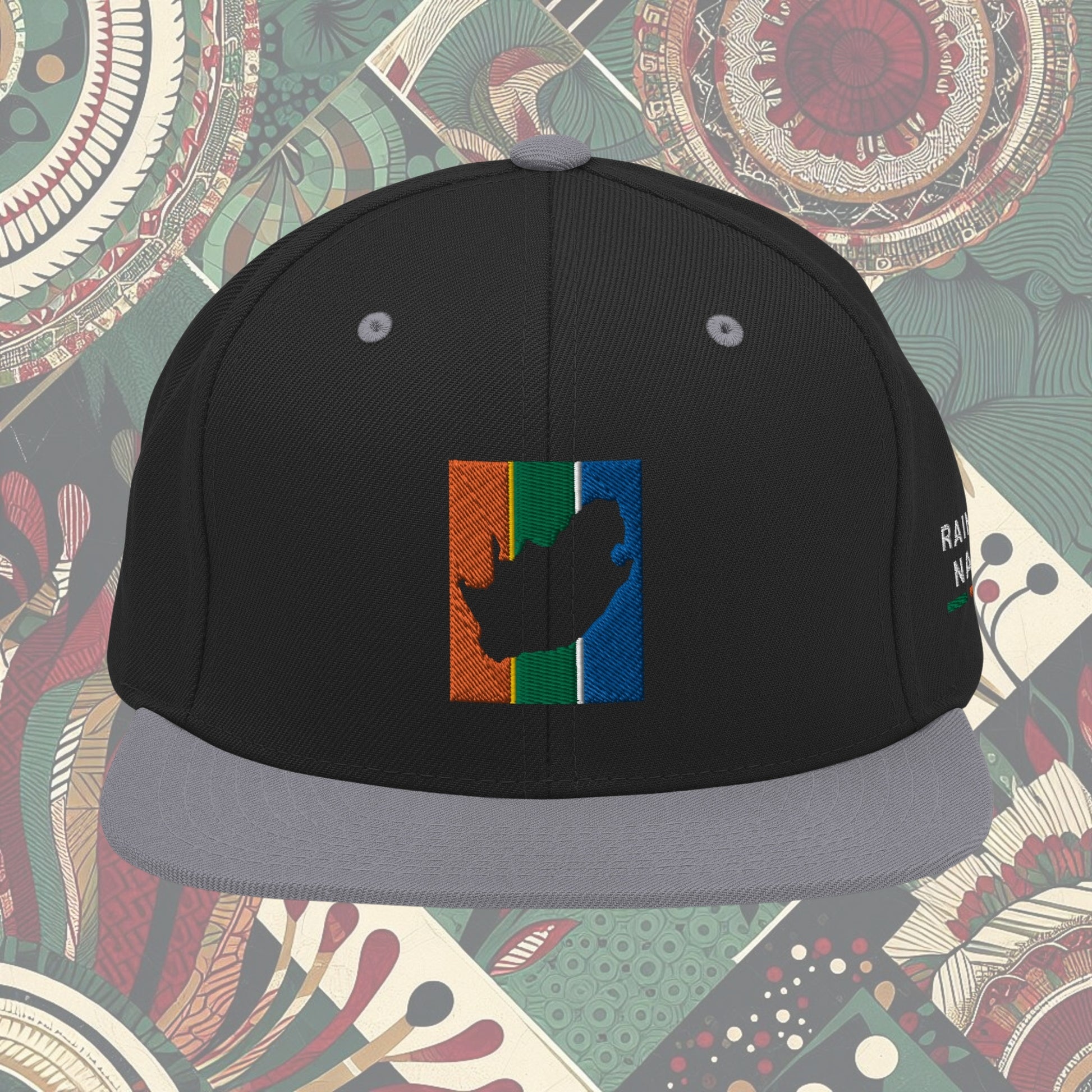 Grey brim South Africa flag snapback with 'Rainbow Nation' written on the side. Features vibrant flag colors and a statement celebrating South Africa's diversity. Ideal for showcasing pride and enhancing your style.