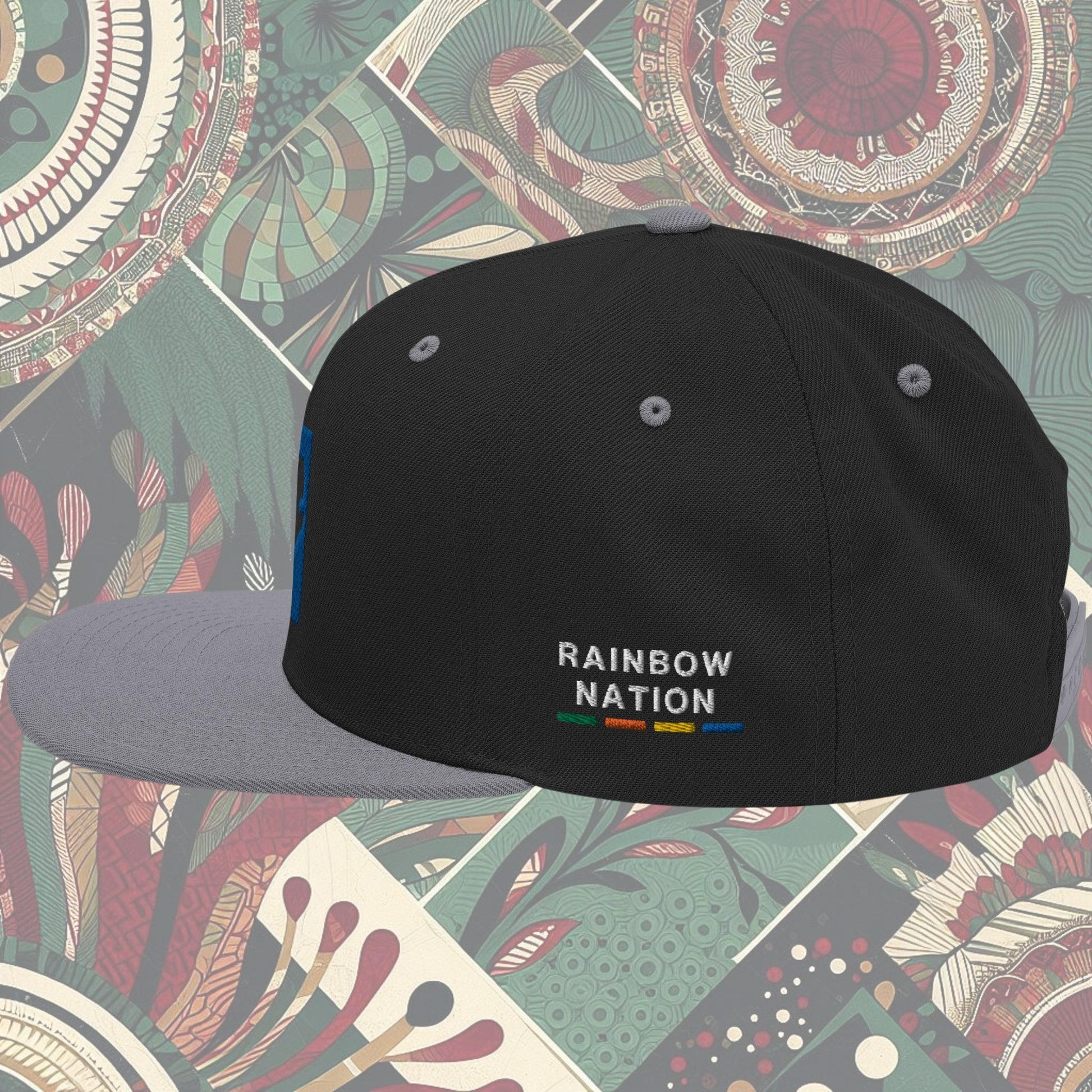 Grey brim South Africa flag snapback with 'Rainbow Nation' written on the side. Features vibrant flag colors and a statement celebrating South Africa's diversity. Ideal for showcasing pride and enhancing your style.