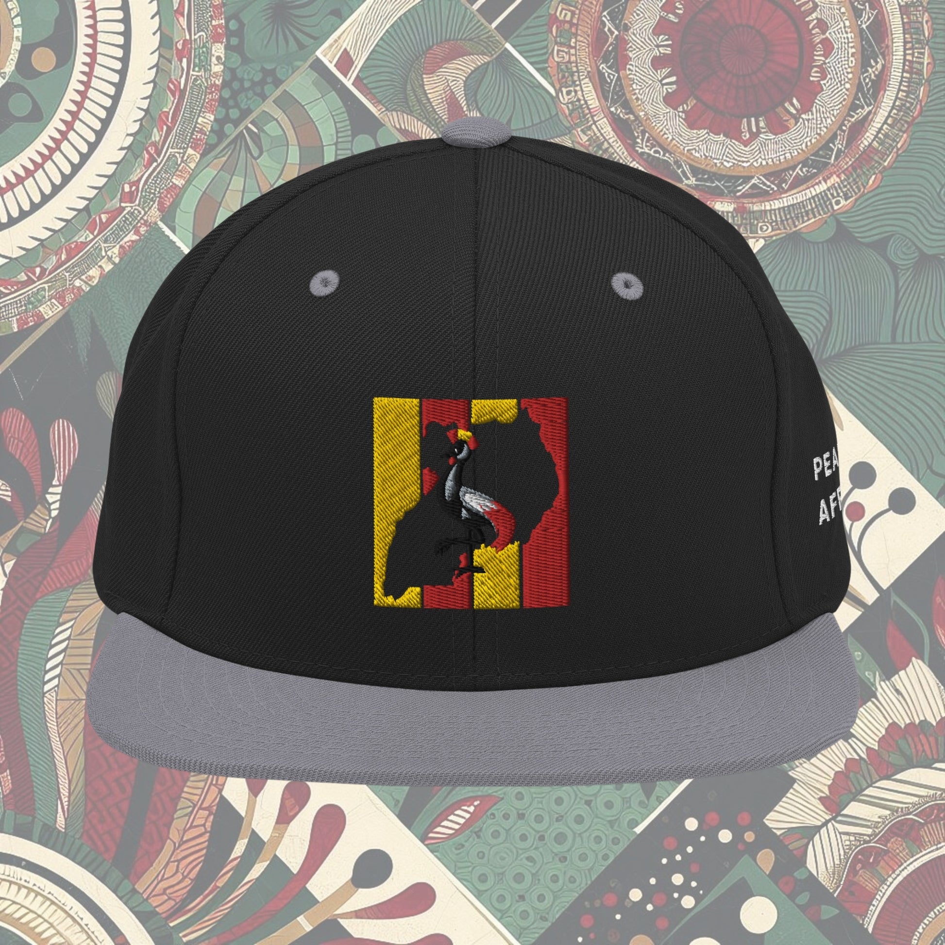 grey brim Uganda flag snapback with 'Pearl of Africa' written on the side. Vibrant flag colors and a stylish statement piece for showing pride and supporting unique fashion