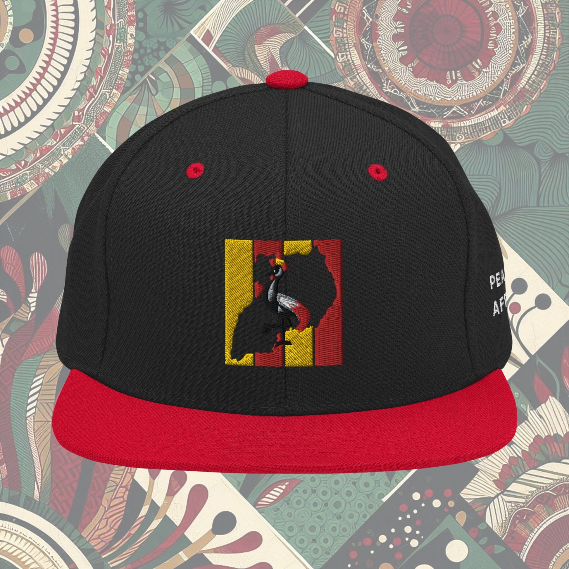 red brim Uganda flag snapback with 'Pearl of Africa' written on the side. Vibrant flag colors and a stylish statement piece for showing pride and supporting unique fashion